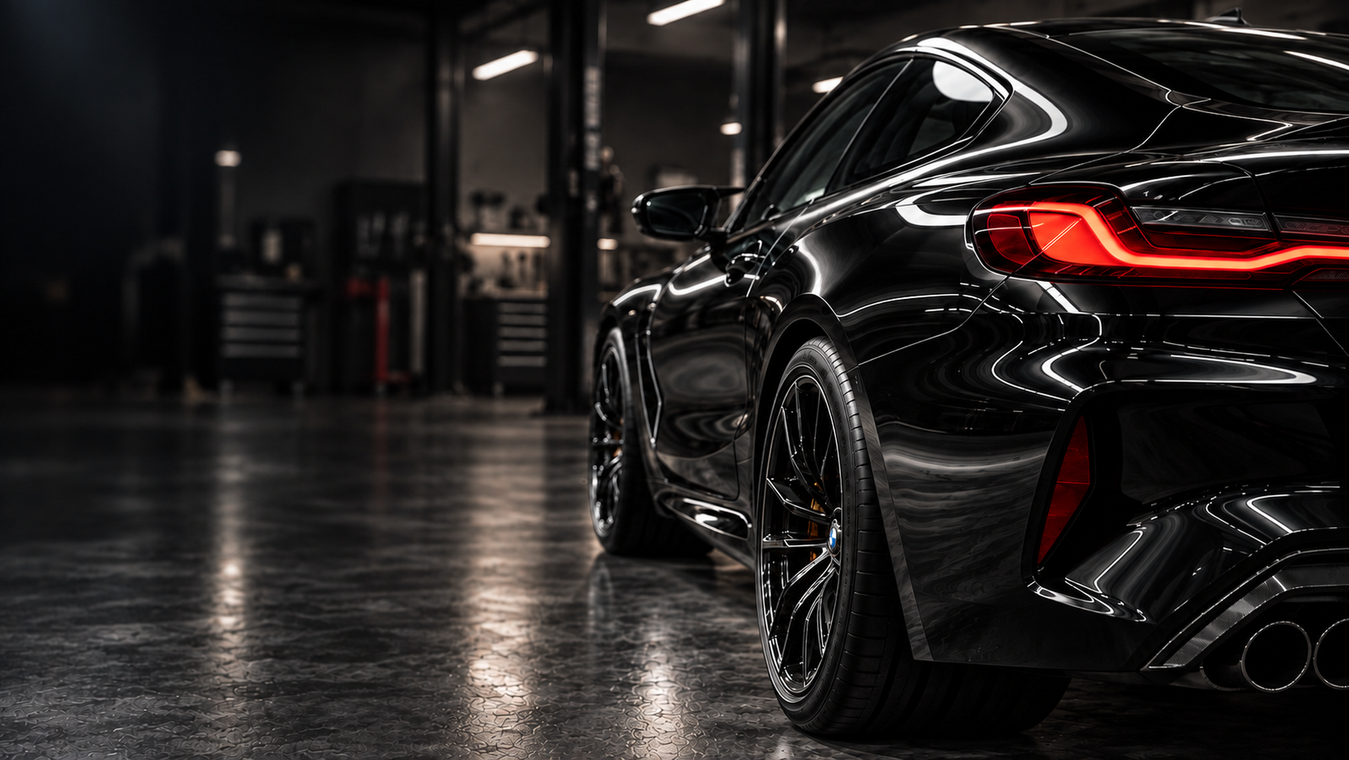 Black BMW M8 in an automotive workshop