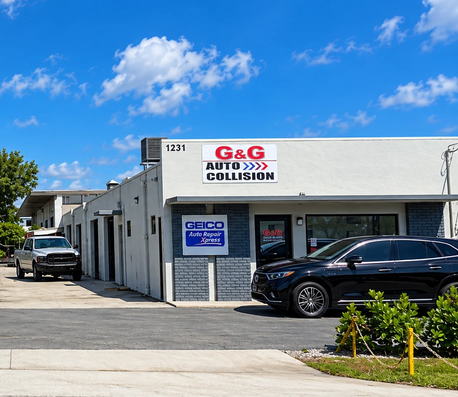 Exterior of G&G Auto Collision's West Palm Beach shop, showing the shop signage, front entrance, and vehicles parked outside.